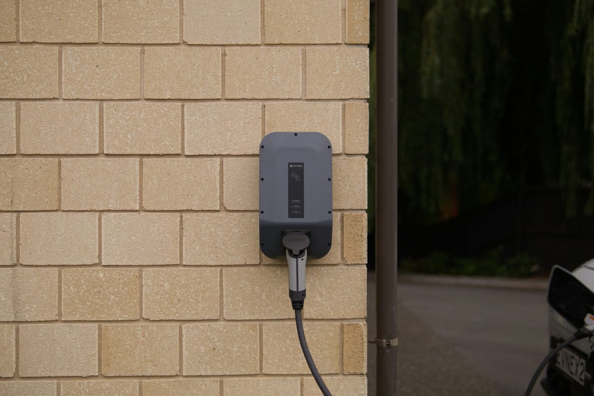 Wall-mounted electric vehicle charger and cable
