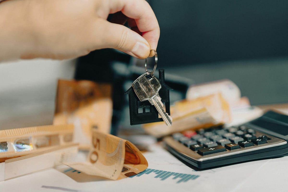 House key and calculator as a neutral homeownership-planning image