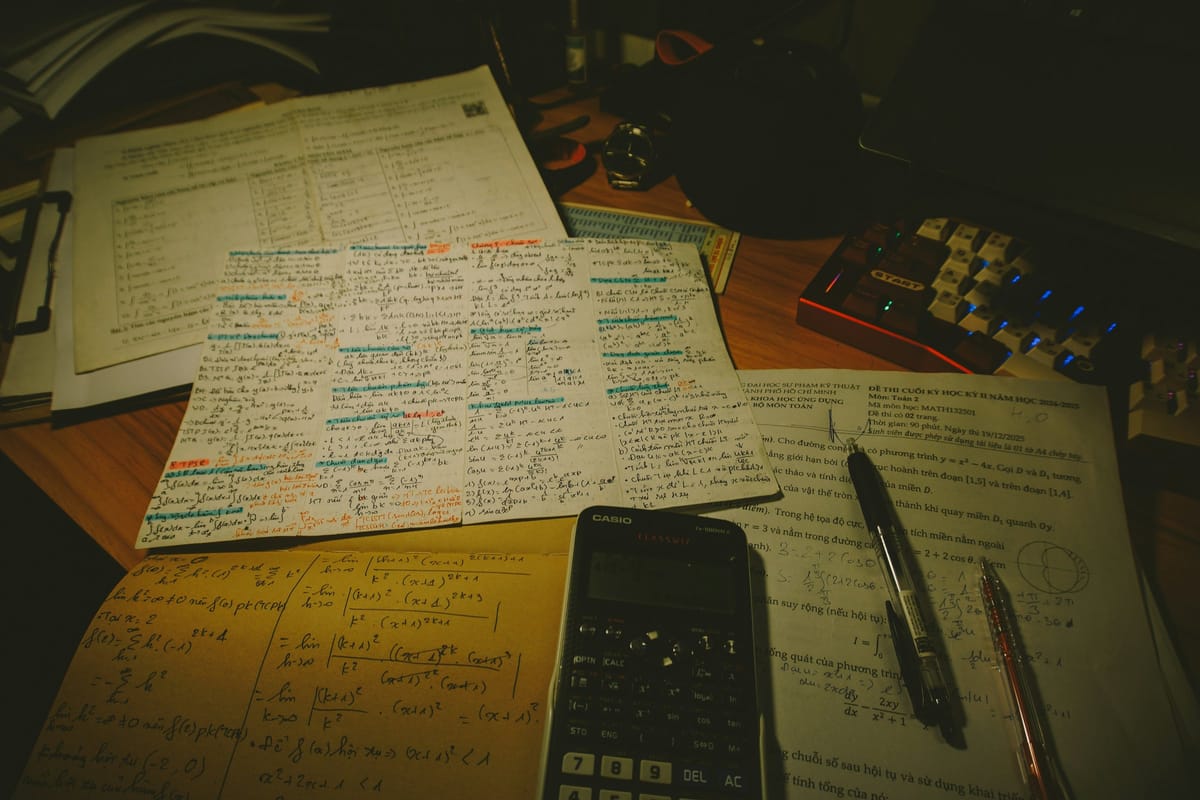 Desk with papers, calculator, and pens for a document-checking explainer