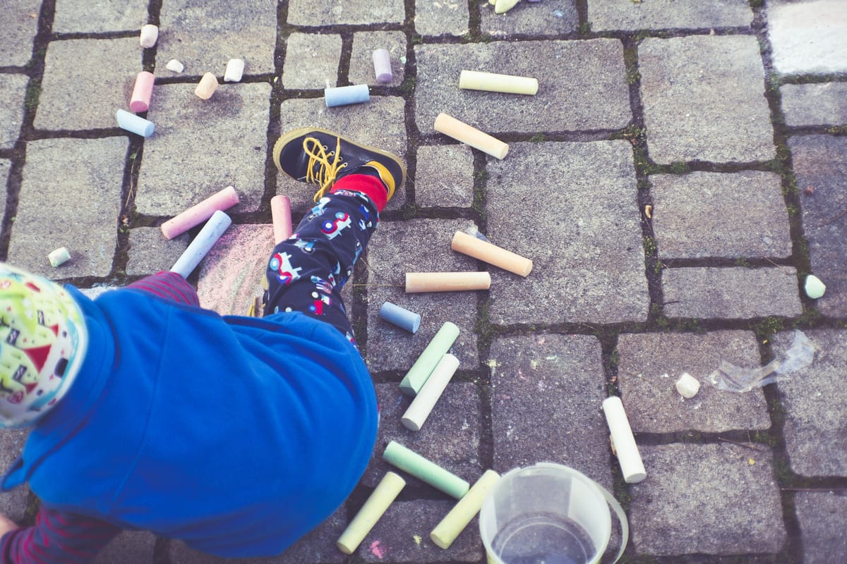 Child engaged in creative learning with books or drawing materials