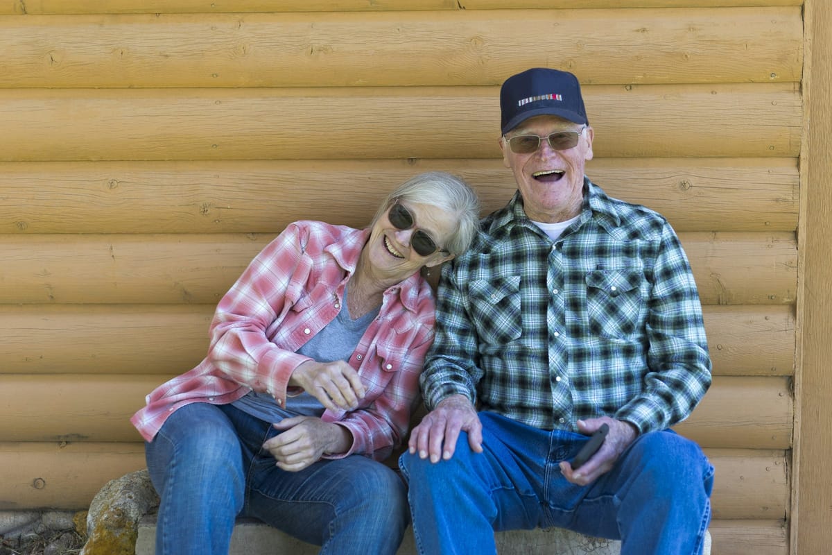 Older couple sitting together outdoors