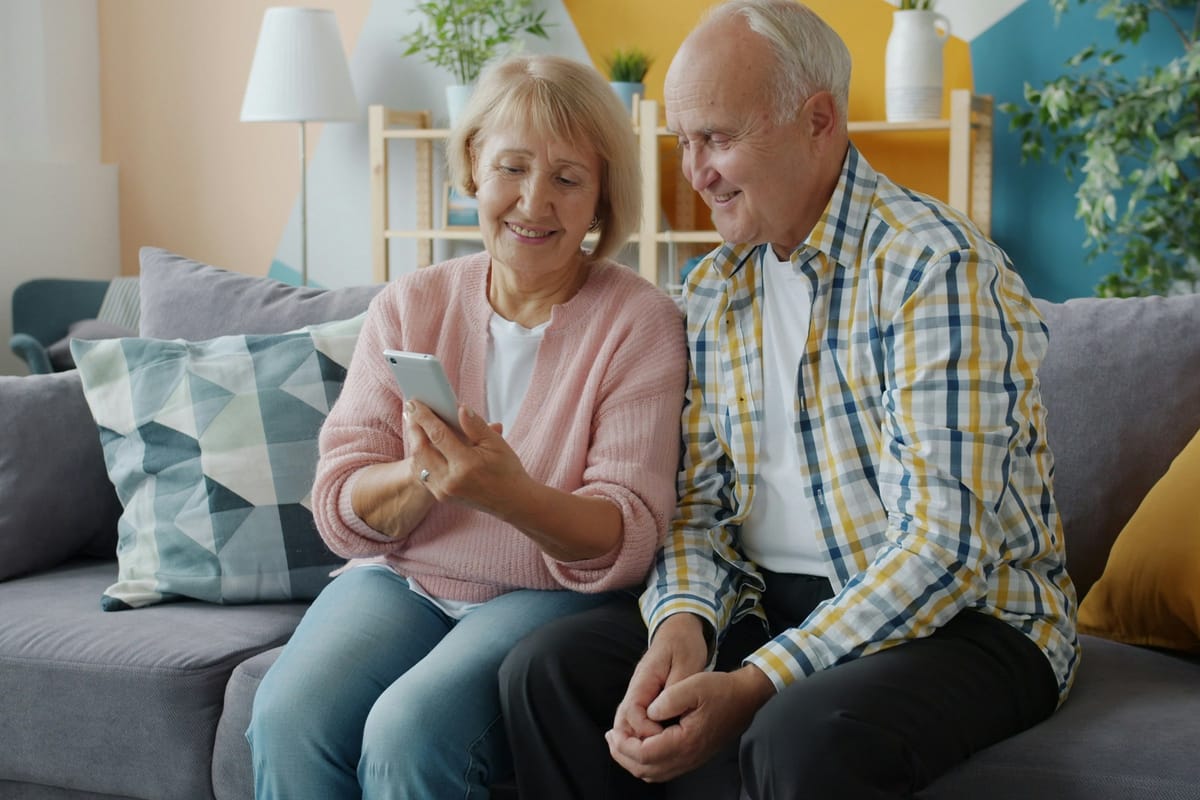 Older couple using a smartphone together at home