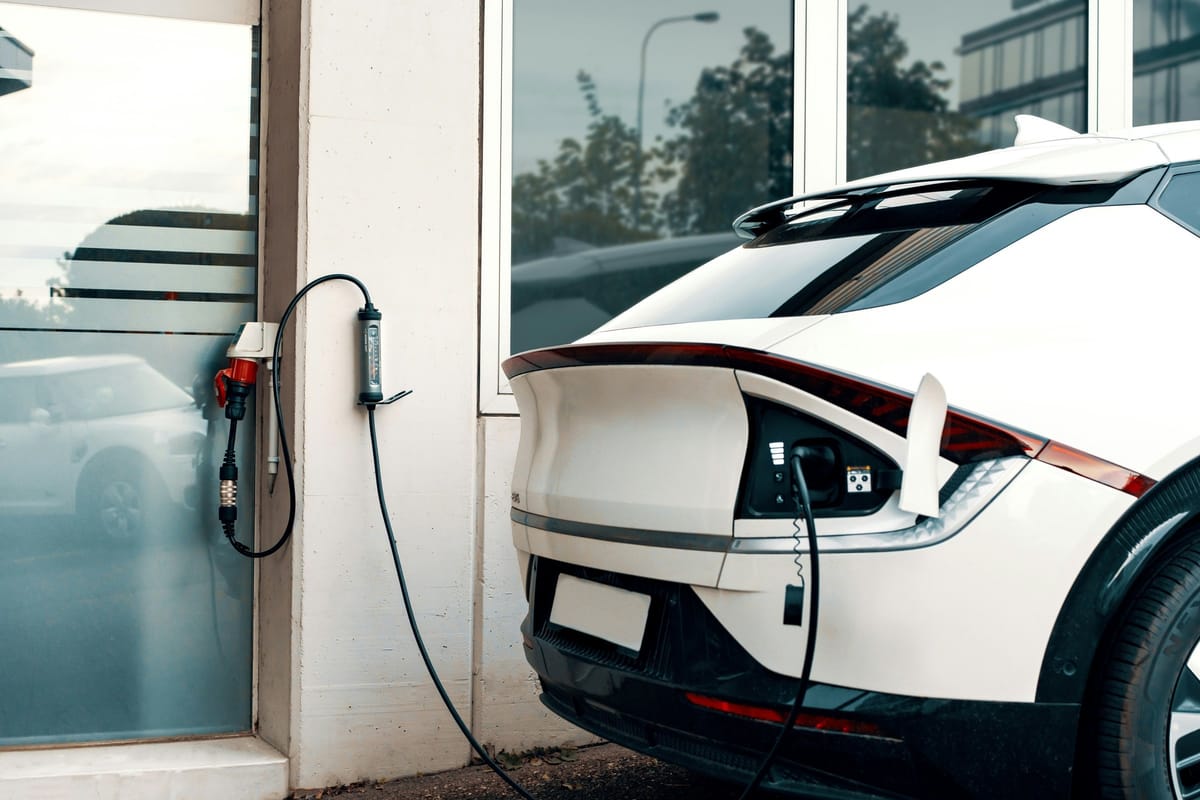 home EV charging installation; no visible people or faces; no readable text or logos; residential context
