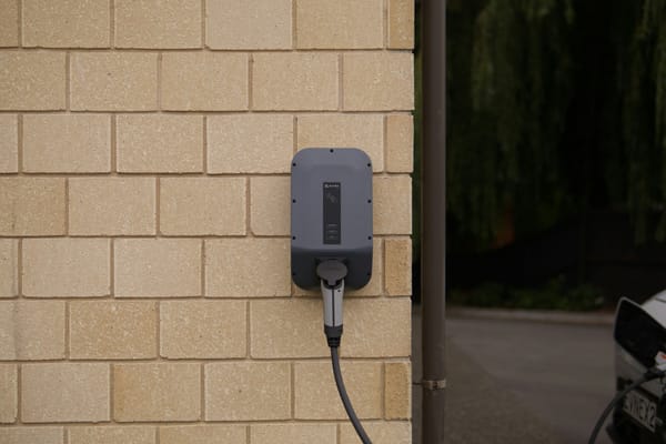 Wall-mounted electric vehicle charger and cable