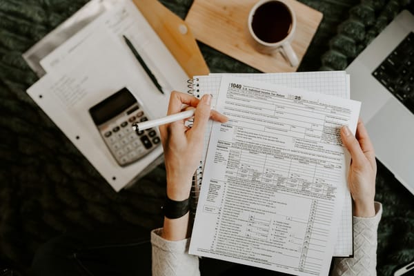 Documents and calculator on a desk for a Canadian business tax update