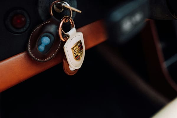 Close editorial view of a vehicle key and car surface, no visible brand emphasis