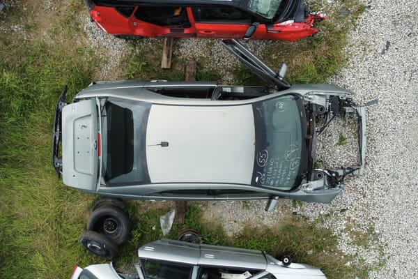 Aerial view of older vehicles in a yard, suggesting inspection history and ownership risk