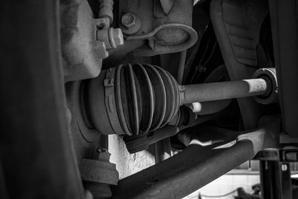 Detailed but non-graphic underside vehicle repair image for a maintenance explainer