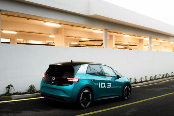 Blue electric hatchback on a road, clean ownership-focused image