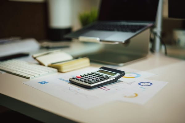 Calculator and laptop on a home-office desk