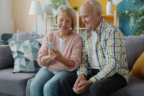 Older couple using a smartphone together at home