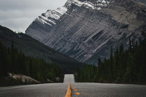 Empty road leading toward a mountain in Jasper